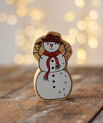 Lanka Kade Snowman Christmas wooden toy figure placed on a wooden surface in the Babipur playroom.
