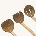 A close up of the 3 Lanka Kade coconut utensils set showing the spade, rake and colander on wooden handles.