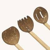 A close up of the 3 Lanka Kade coconut utensils set showing the spade, rake and colander on wooden handles.