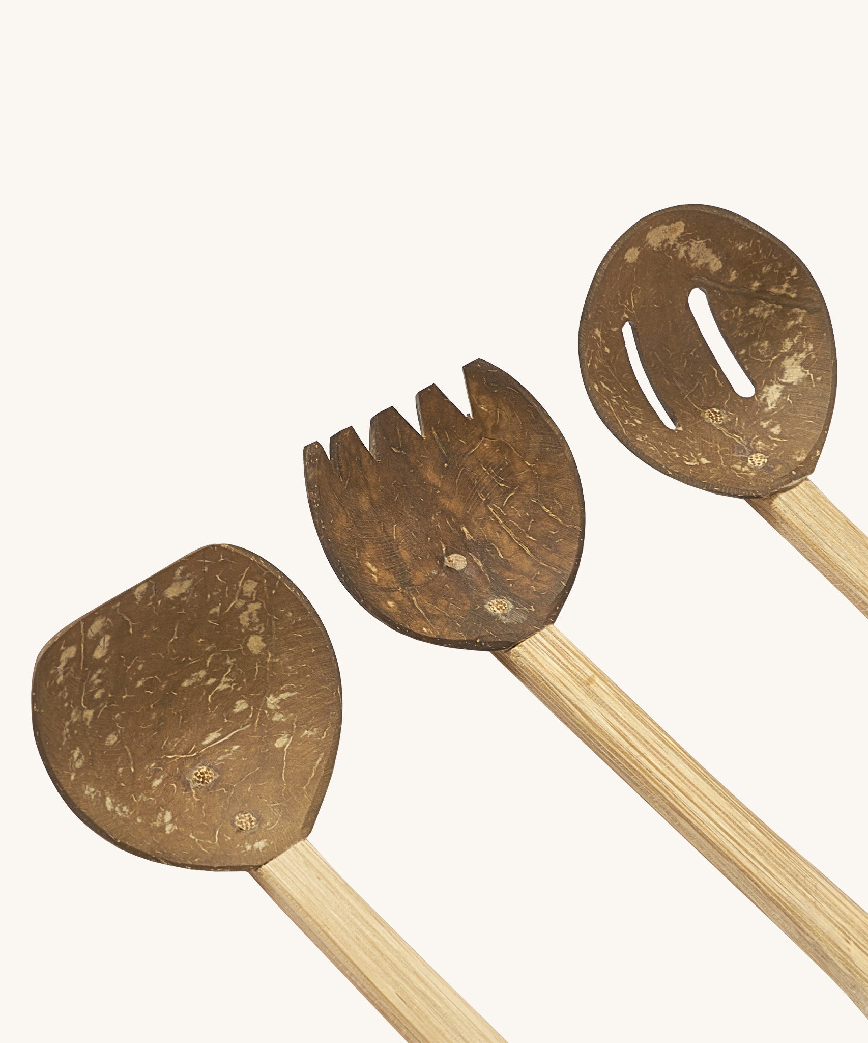 A close up of the 3 Lanka Kade coconut utensils set showing the spade, rake and colander on wooden handles.