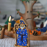 A Lanka Kade Wizard placed on a striped tablecloth with a Halloween themed Grimm's celebration ring set up in the background. 