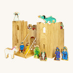 Lanka Kade wooden castle set with 12 wooden figures including a fairy, king and queen, dragon, knight, wizard, witch, gremlin, troll, prince and princess and a unicorn figure. Castle features 2 walls and a drawbridge with a lowering gate