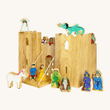 Lanka Kade wooden castle set with 12 wooden figures including a fairy, king and queen, dragon, knight, wizard, witch, gremlin, troll, prince and princess and a unicorn figure. Castle features 2 walls and a drawbridge with a lowering gate