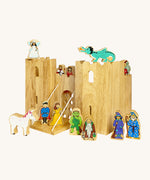 Lanka Kade wooden castle set with 12 wooden figures including a fairy, king and queen, dragon, knight, wizard, witch, gremlin, troll, prince and princess and a unicorn figure. Castle features 2 walls and a drawbridge with a lowering gate