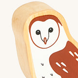 A close up of the A close up of the chunky wooden Lanka Kade brown owl animal figure showing it's facial features and feather detail. Ths figure is available at Babipur.