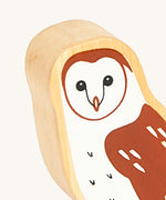 A close up of the A close up of the chunky wooden Lanka Kade brown owl animal figure showing it's facial features and feather detail. Ths figure is available at Babipur.