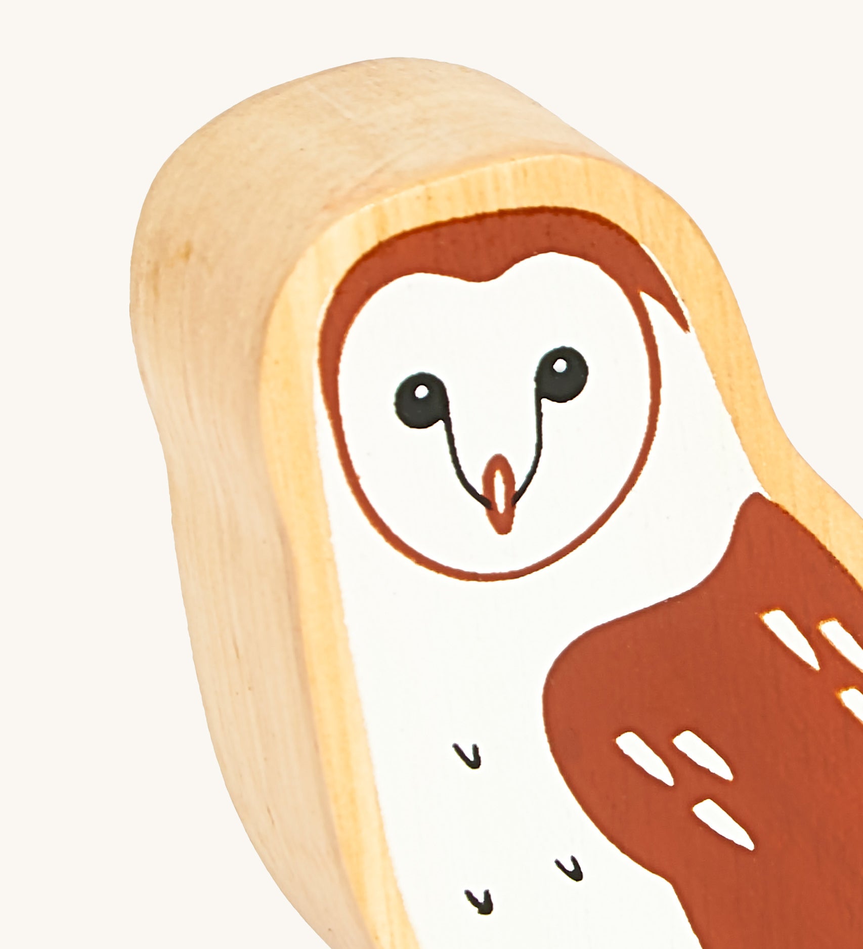 A close up of the A close up of the chunky wooden Lanka Kade brown owl animal figure showing it's facial features and feather detail. Ths figure is available at Babipur.