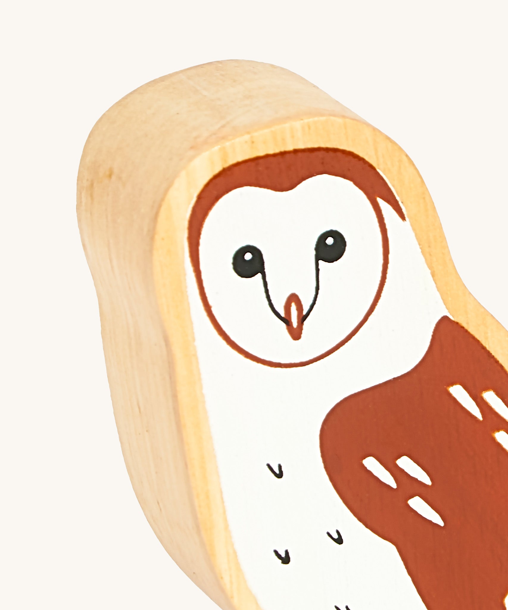 A close up of the A close up of the chunky wooden Lanka Kade brown owl animal figure showing it's facial features and feather detail. Ths figure is available at Babipur.