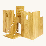 Side view of the  wooden Lanka Kade castle showing the corner walls with window holes, the lowered drawbridge and the gate lifted
