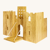 Side view of the  wooden Lanka Kade castle showing the corner walls with window holes, the lowered drawbridge and the gate lifted