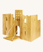 Side view of the  wooden Lanka Kade castle showing the corner walls with window holes, the lowered drawbridge and the gate lifted