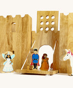 A close up of the drawbridge lowered and the gate lifted from the Lanka Kade wooden castle set showing the prince, princess fairy and unicorn figure in a fairytale setup.