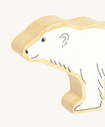 A close up of the chunky wooden Lanka Kade polar bear animal figure showing it's facial features and fur detail. Ths figure is available at Babipur.