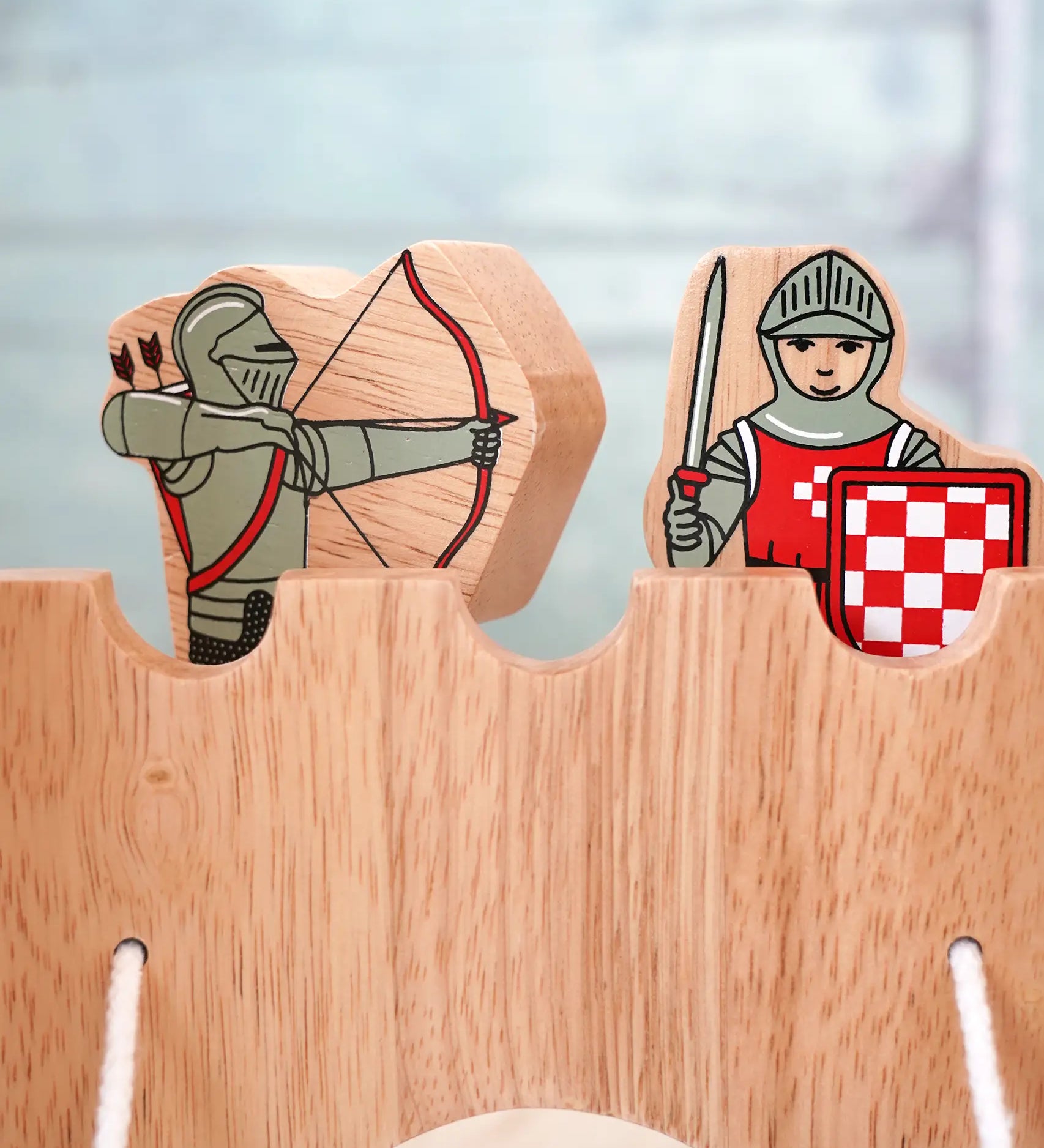Lanka Kade wooden red armoured knight archer standing next to a standing knight figure on top of a wooden castle