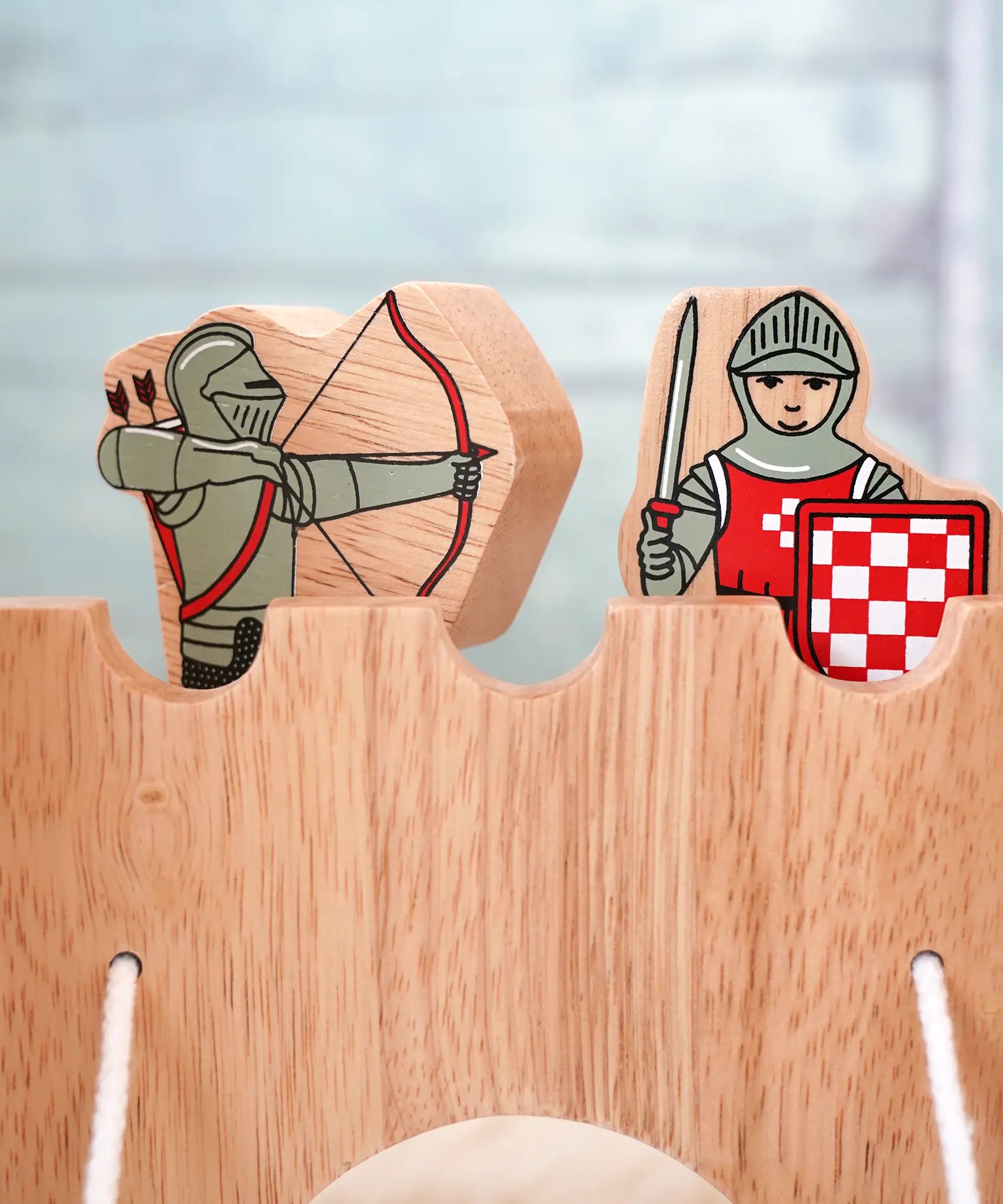 Lanka Kade wooden red armoured knight archer standing next to a standing knight figure on top of a wooden castle