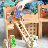 A Lanka Kade wooden toy castle with fairytale themed character figures placed in and around the castle.