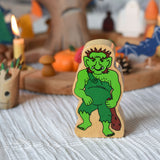 A Lanka Kade wooden troll figure placed in front of an Autumnal Halloween themed celebration ring set up. 