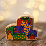 Lanka Kade wrapped presents wooden wooden toy figure placed on a wooden surface in the Babipur playroom.