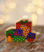 Lanka Kade wrapped presents wooden wooden toy figure placed on a wooden surface in the Babipur playroom.