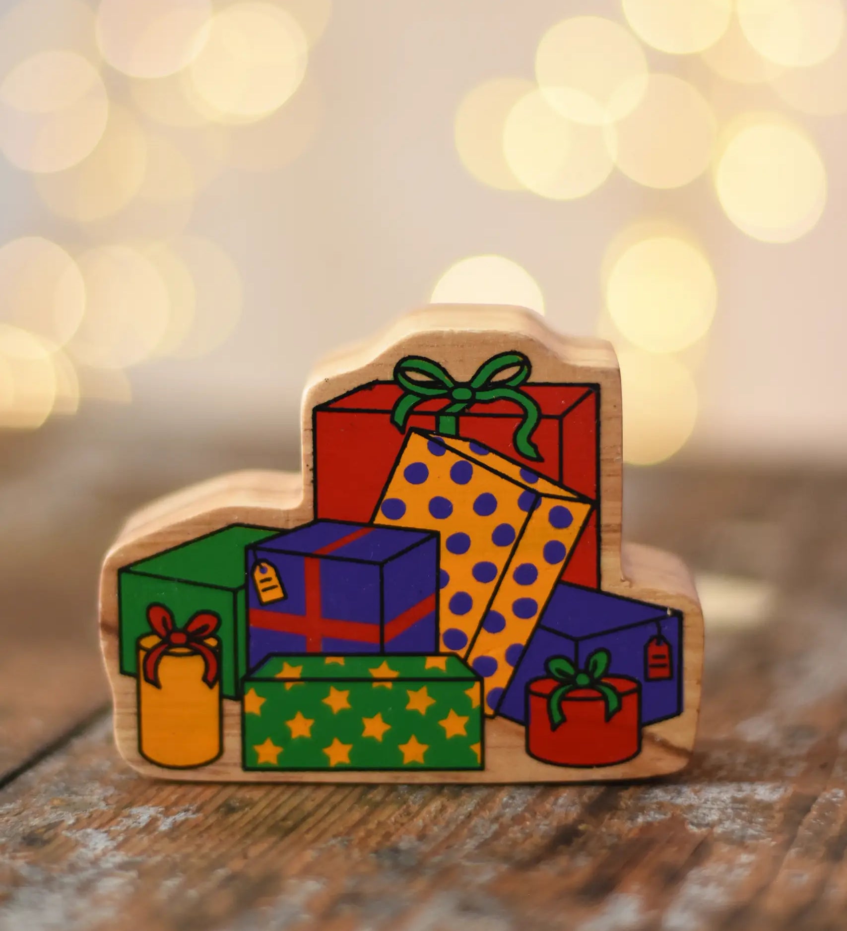 Lanka Kade wrapped presents wooden wooden toy figure placed on a wooden surface in the Babipur playroom.