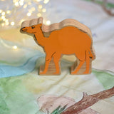 A Lanka Kade camel wooden toy figure placed on a Wonderie play cloth. These wooden toy figures are part of a huge range of Lanka Kade fair trade, wooden toys available here at Babipur.