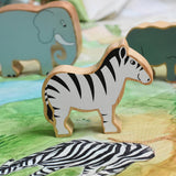 A Lanka Kade Zebra wooden toy figure placed on a Wonderie plains of Africa play cloth. These wooden toy figures are part of a huge range of Lanka Kade fair trade, wooden toys available here at Babipur.
