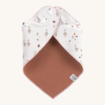 The Lassig goose dribble bib for babies, fastened with poppers at the neck. 