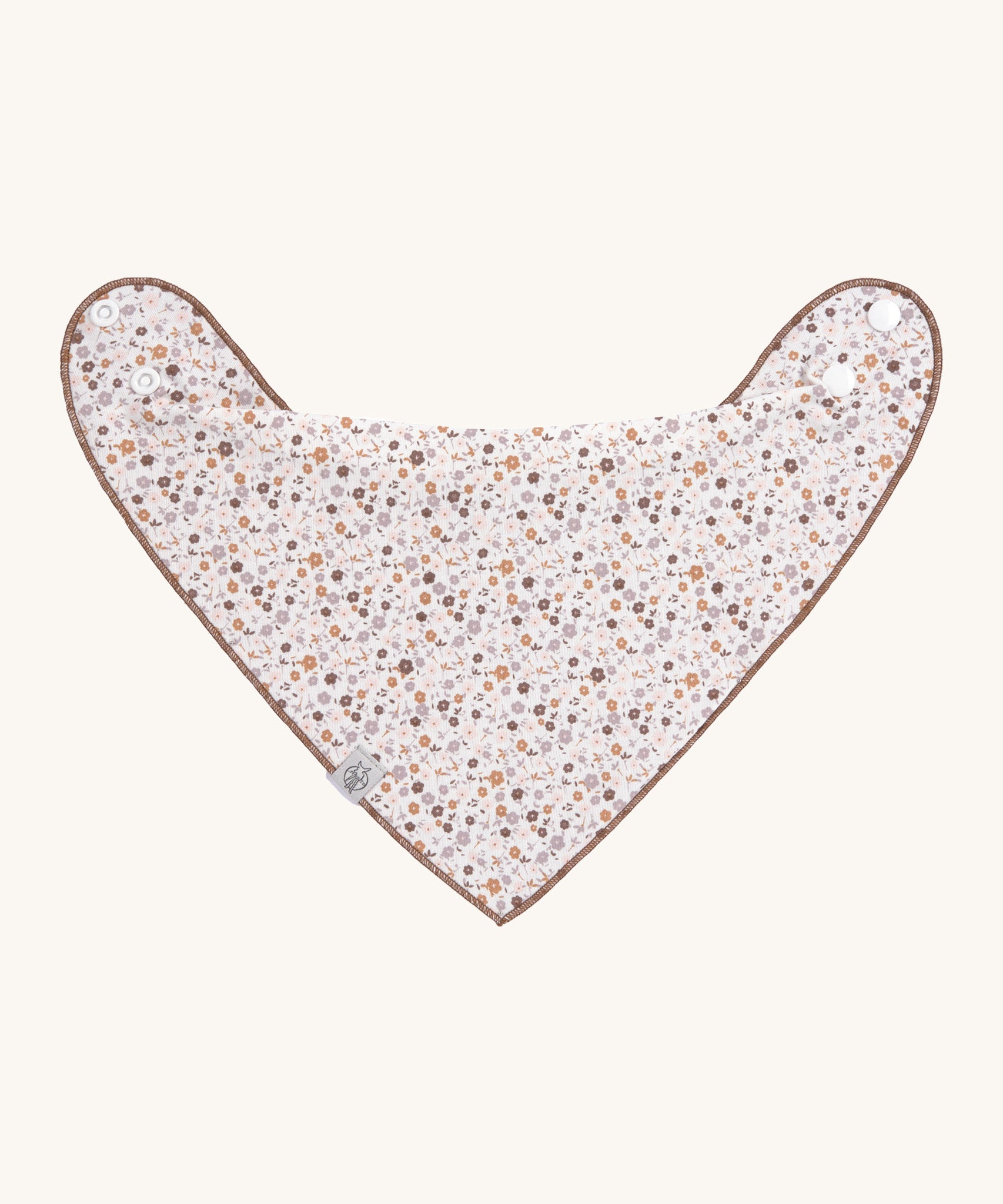 The Lassig baby bandana bib with a floral pattern. 