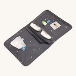The Lassig recycled polyester baby change pouch in a dark anthracite grey, opened to show to inside pockets and compartments.