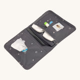 The Lassig recycled polyester baby change pouch in a dark anthracite grey, opened to show to inside pockets and compartments.