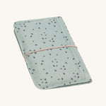 The Lassig baby changing pouch made from 100% recycled polyester, in a floral mint green pattern.