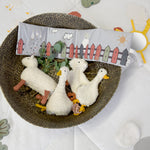 The Lassig Baby Touch & Feel soft toy book, in a basket with other Lassig soft toys.