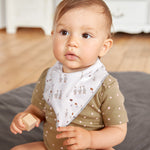 A baby wearing the Lassig organic bandana dribble bib, in white with little geese printed all over. 