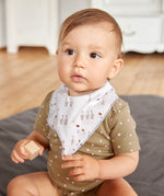 A baby wearing the Lassig organic bandana dribble bib, in white with little geese printed all over. 
