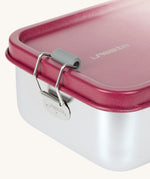 A close up of the clasp closure on the Lassig Stainless Steel Lunchbox in a Unique Berry Rose colour. This stainless steel lunch box has a removable divider.