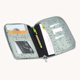 The Lassig Document Pouch with a Floral Mint design shown open with things inside. The document storage pouch has a zipped closure to keep the content safe and secure. Lassig have a range of bags and accessories available at Bbaipur.
