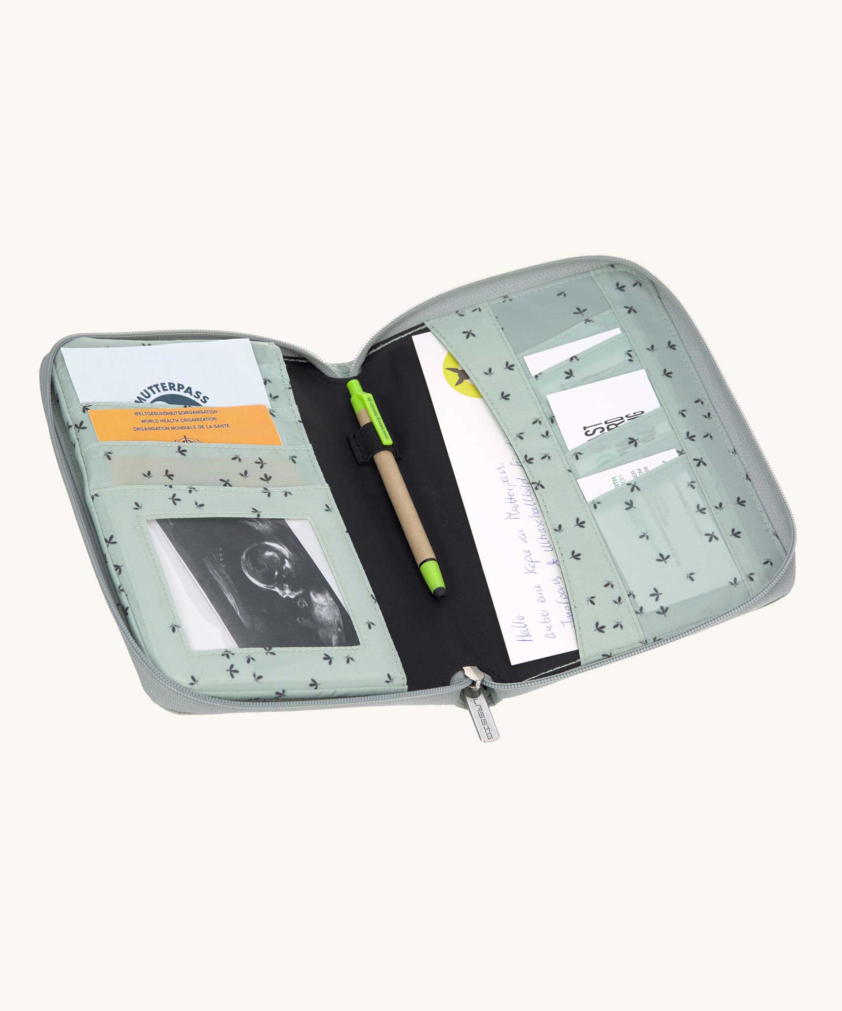 The Lassig Document Pouch with a Floral Mint design shown open with things inside. The document storage pouch has a zipped closure to keep the content safe and secure. Lassig have a range of bags and accessories available at Bbaipur.