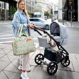 A woman with a pram and the Lassig every day change nappy bag in light khaki.