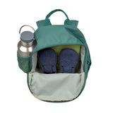 A top view of an opened Lassig mini backpack for kids in a dark green colour, to show how you can use it to store shoes, books, and a water bottle. 