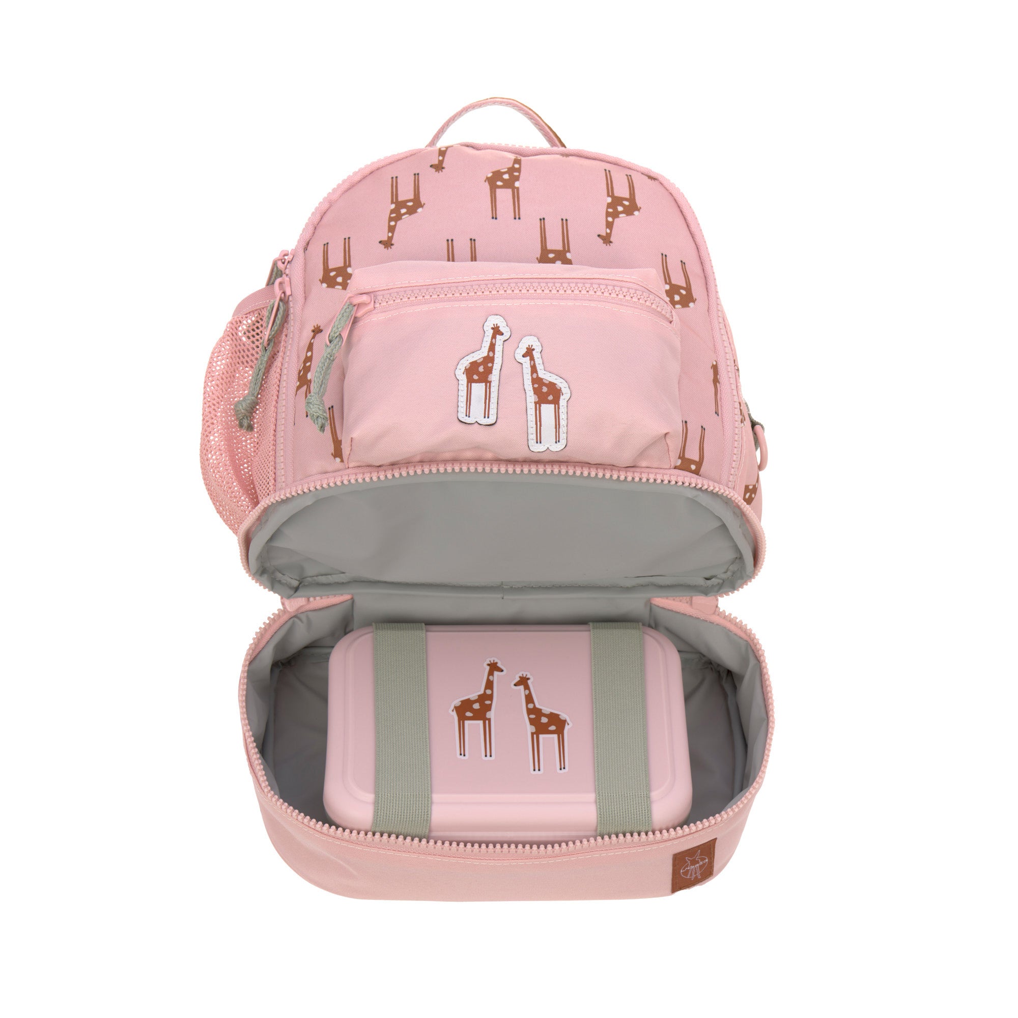 The Lassig kids mini backpack in a Safari Giraffe pink print, with the bottom zip opened to reveal a storage compartment with a lunchbox inside. 