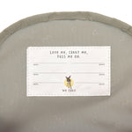 The inside of the Lassig kids mini backpack, showing the name label with space for multiple names, as this bag is designed to be passed onto younger siblings and friends. 