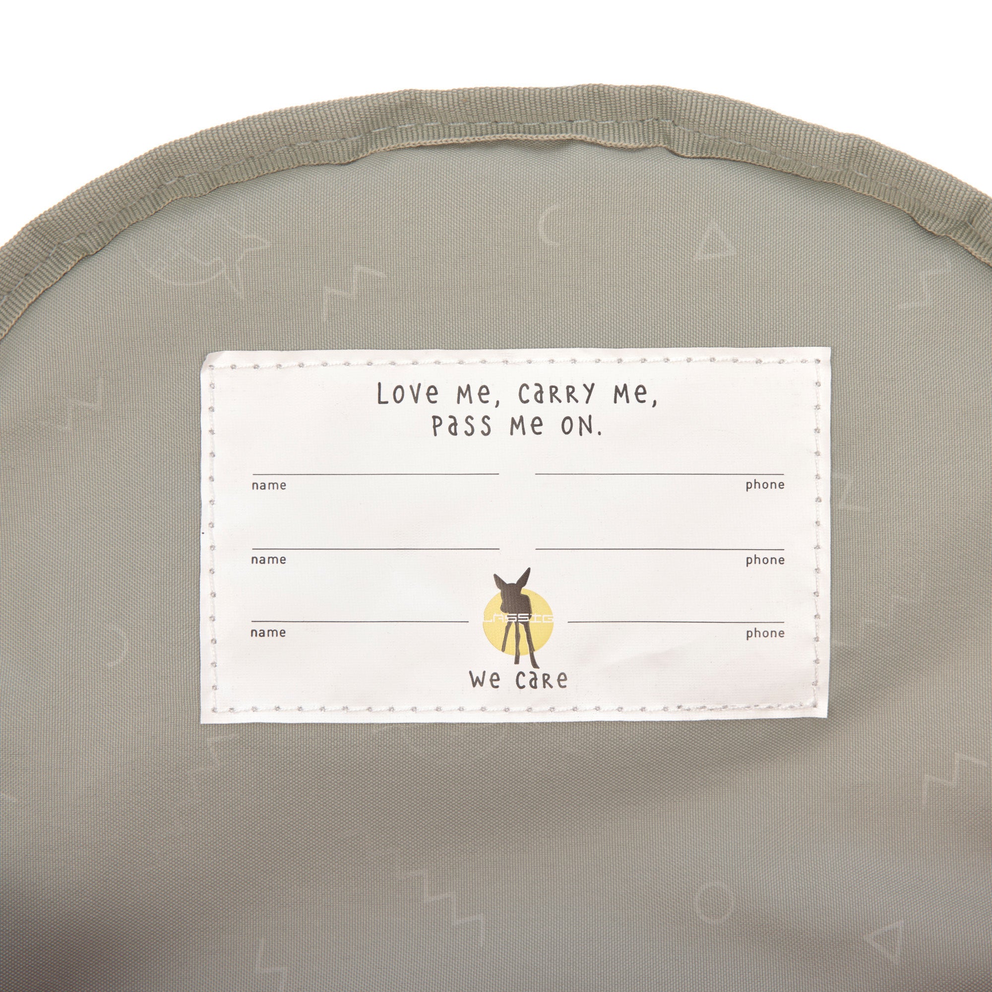 The inside of the Lassig kids mini backpack, showing the name label with space for multiple names, as this bag is designed to be passed onto younger siblings and friends. 