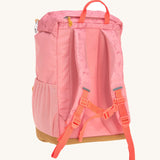 The back of the Lassig Kids Big Outdoor Backpack with an Adventure rose pink design showing the bright pink chest straps. The print features tents, trees, and clouds, and a pink front strap. These children's backpacks are part of a wide range available at Babipur.