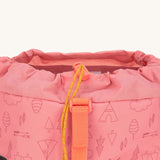 A close up of the toggle closure on the Lassig Kids Big Outdoor Backpack with an Adventure rose pink design. The print features tents, trees, and clouds, and a pink front strap. These children's backpacks are part of a wide range available at Babipur.