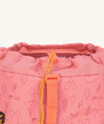 A close up of the toggle closure on the Lassig Kids Big Outdoor Backpack with an Adventure rose pink design. The print features tents, trees, and clouds, and a pink front strap. These children's backpacks are part of a wide range available at Babipur.