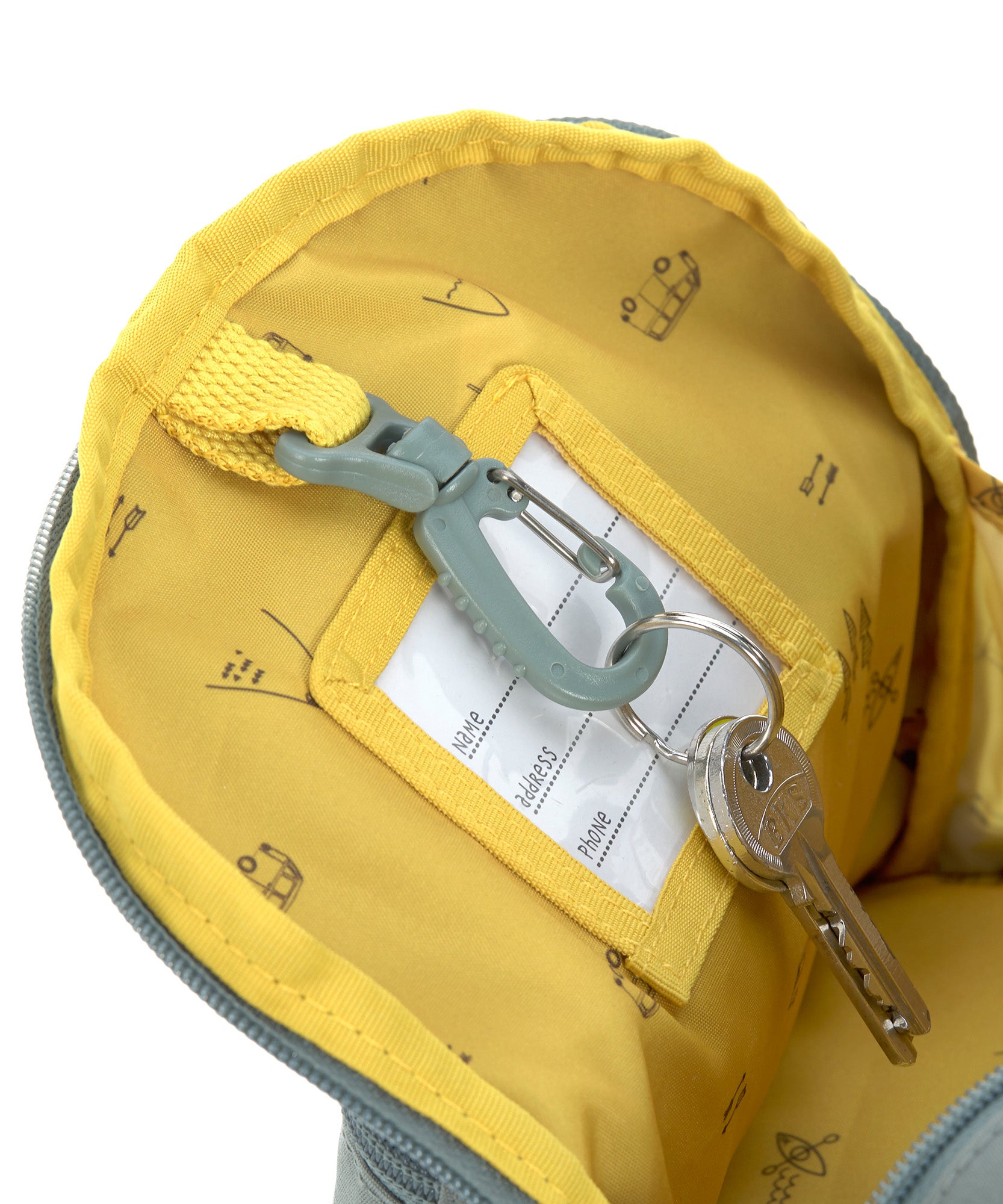 The inside of the Lassig kids mini adventure backpack, with a handy hook to keep keys attached safe. 