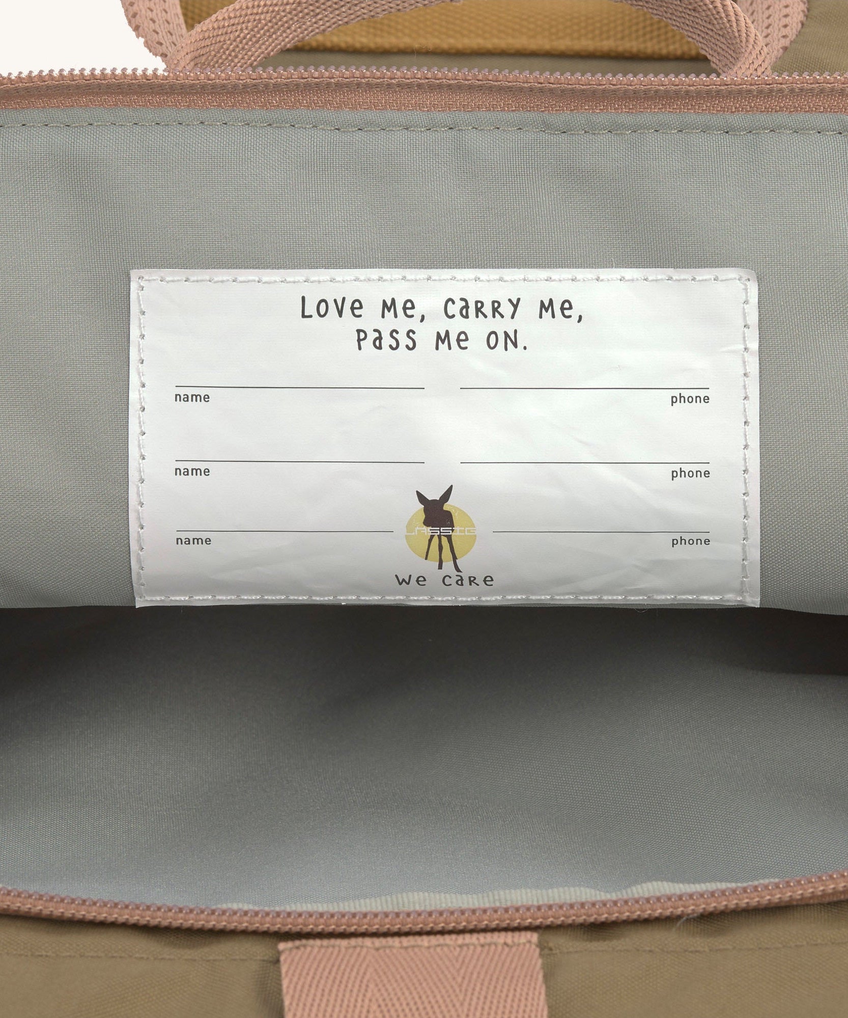 A close up of the name tags inside the Lassig Mini Rolltop Backpack in a Nature Hazelnut colour. This children's bag is part of a wide range of backpacks and accessories available at Babipur. 