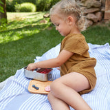 A child eating from a Lassig Stainless Steel Bamboo Lunchbox. This stainless steel lunchbox is part of a wide range of reusable food containers available at Babipur. 