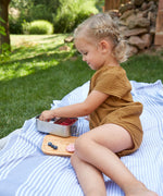 A child eating from a Lassig Stainless Steel Bamboo Lunchbox. This stainless steel lunchbox is part of a wide range of reusable food containers available at Babipur. 