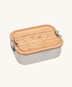 Lassig Stainless Steel Bamboo Lunchbox with an Adventure design. The words let's be wild are written on the bamboo lid. This children's divided lunchbox is part of a wide range of food storage solutions available at Babipur.